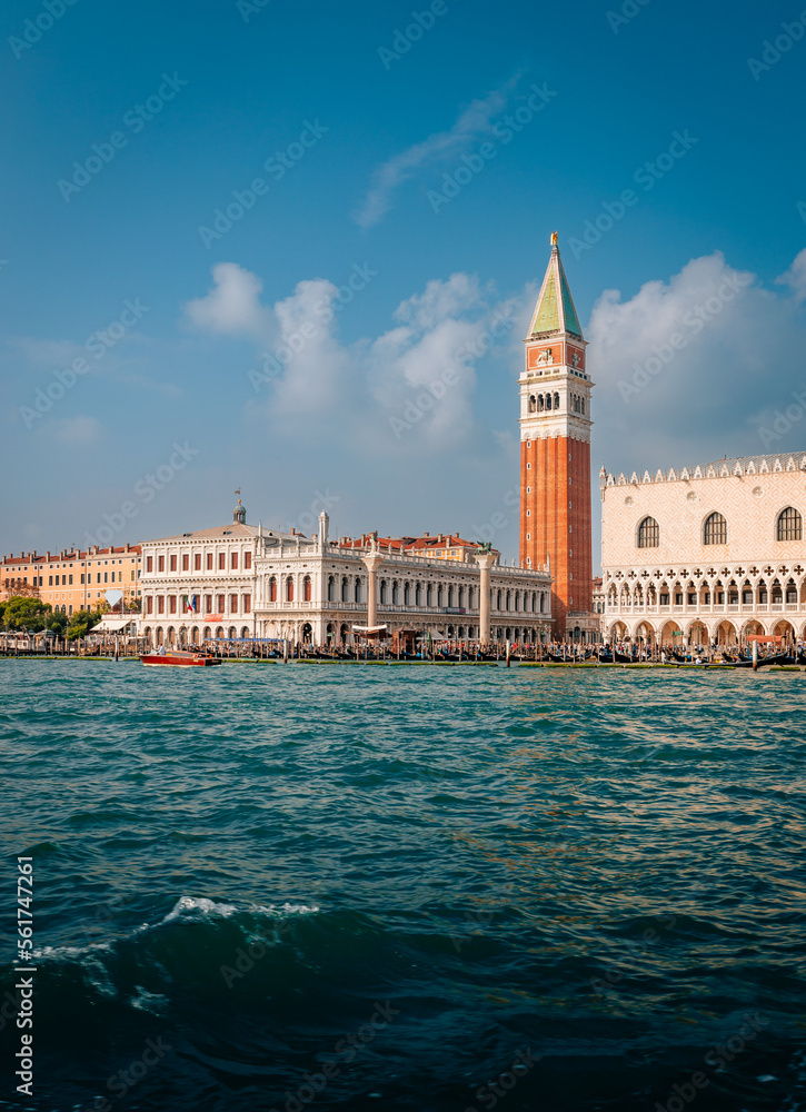 The bell tower of San Marco in Venice taken from the sea with blue sky and clouds