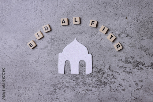 Sticker Eid al fitr word arranged with mosque shape isolated on gray background