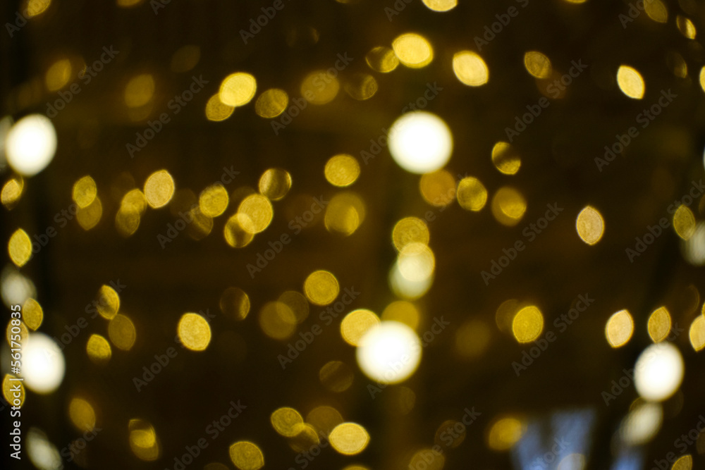 Fototapeta premium Abstract bright background, bokeh of burning yellow light bulbs.