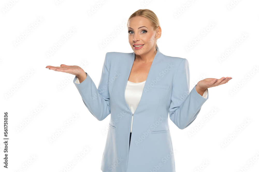Middle aged senior woman with questionable gesture wearing blue jacket and black trousers on a white background Middle aged senior woman with questionable gesture wearing blue jacket and black trousers on a white background