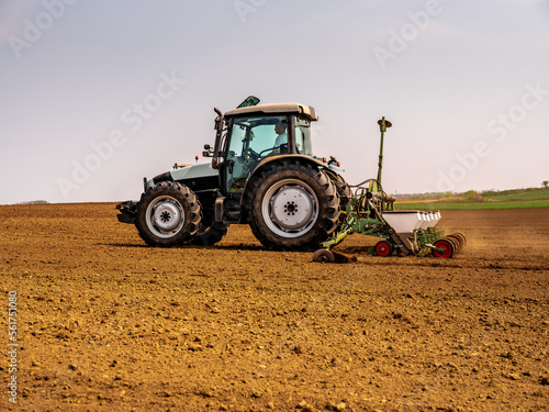 Tractor seeding soybean crops in a farm field