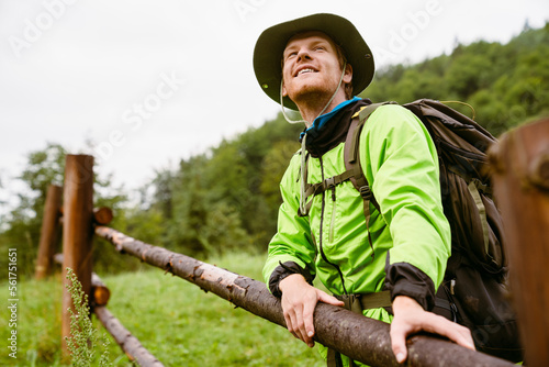 Young white man wearing trekking equipment hiking in mountain forest