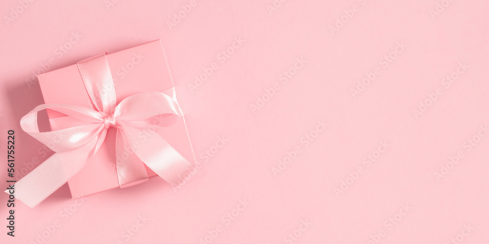 Valentine's Day concept.Top view of beautiful pink gift box with satin bow on isolated pastel pink background. Valentine day minimal cute composition. Flat lay, copy space Valentine's Day concept.Top view of beautiful pink gift box with satin bow on isolated pastel pink background. Valentine day minimal cute composition. Flat lay, copy space