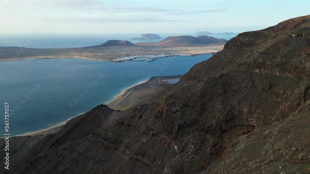 Spain , Lanzarote, Mirador del Rio ( Cesar Manrique ) - Drone aerial view in panoramic costal road overlooking the sea ocean and La Graciosa Island - Travel journey in volcanic landscape Spain , Lanzarote, Mirador del Rio ( Cesar Manrique ) - Drone aerial view in panoramic costal road overlooking the sea ocean and La Graciosa Island - Travel journey in volcanic landscape