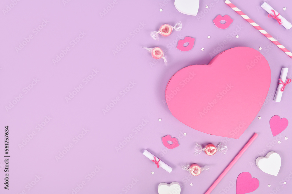 Pastel colored Valentine's Day flat lay with heart shaped gift box, heart ornaments and candy on violet background with copy space