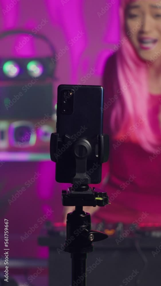 Vertical video: Performer recording song process with phone camera, mixing and mastering electronic sound preparing eletronic album. Dj artist performing techno music using professional audio Vertical video: Performer recording song process with phone camera, mixing and mastering electronic sound preparing eletronic album. Dj artist performing techno music using professional audio