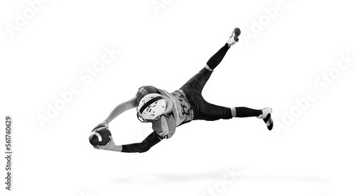 Black and white photography. Man, american football player in motion, training over white studio background. Concept of sport, competition