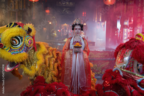 Girl in Chinese traditional dress in temple translation language is 'lucky and prosperity for all' photo