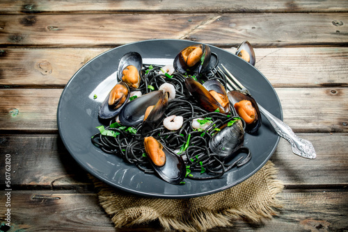 Mediterranean food. Spaghetti with cuttlefish black ink and clams.