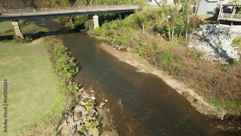 Aerial pass under bridge following creek in Old Town Helena, Alabama Aerial pass under bridge following creek in Old Town Helena, Alabama