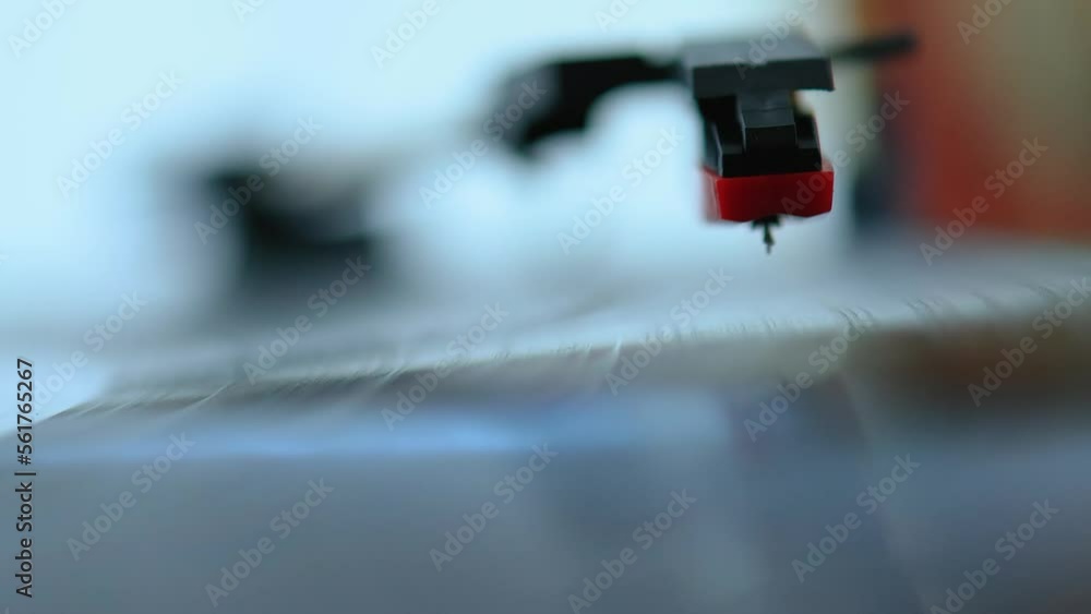 Placing the needle on the surface of a vinyl on top of an old record player Placing the needle on the surface of a vinyl on top of an old record player