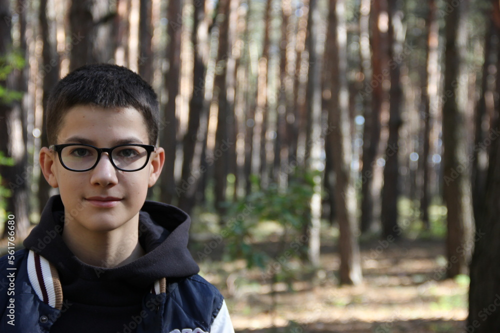 portrait of a teenager on the background of a blurred forest portrait of a teenager on the background of a blurred forest