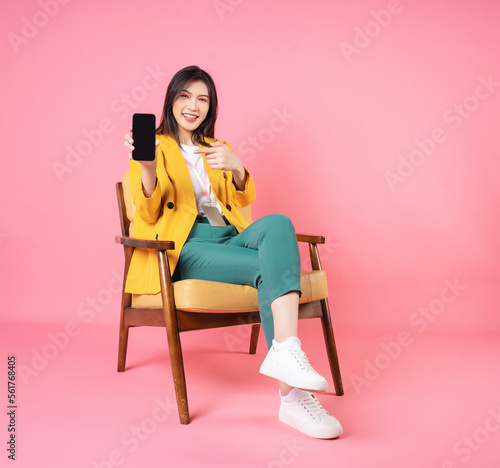 Image of young Asian businesswoman sitting on chair photo