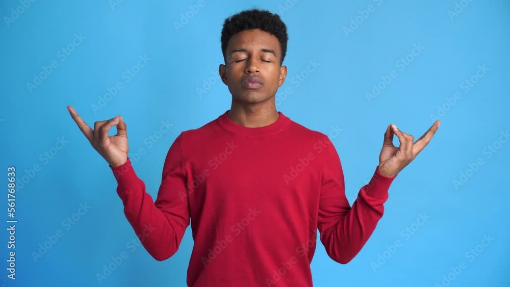 Cheerful black man doing meditation exercises Cheerful black man doing meditation exercises