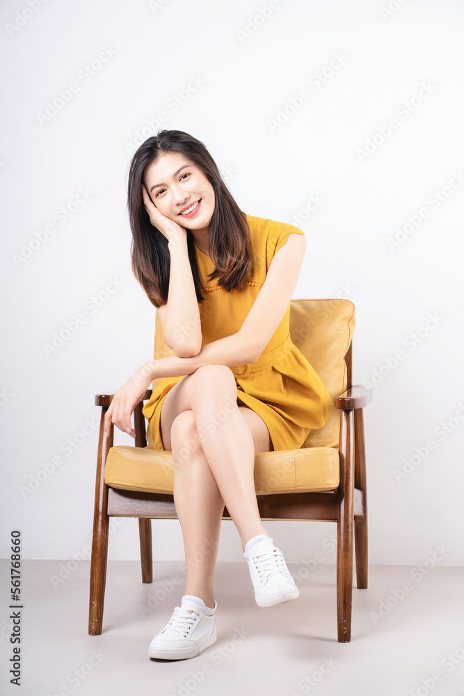Image of young Asian woman sitting on chair Image of young Asian woman sitting on chair