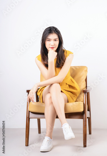 Image of young Asian woman sitting on chair