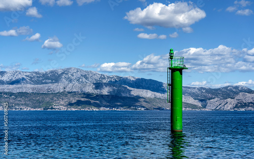 Lighthouse pillar in front of the coast