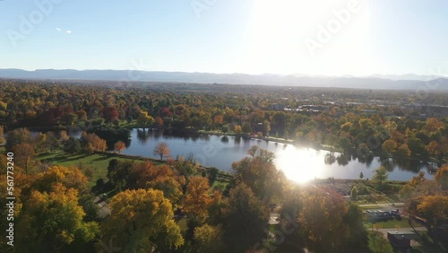Beautiful autumn landscape of Wash Park with flathead lake and sunlight shining through the water, mountain range in the background, Denver, Colorado photo