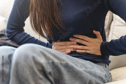 Fotobehang young woman gripping her stomach have abdominal pain .