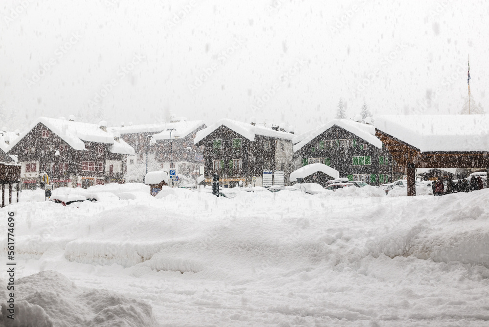 Bad weather and heavy snow in the mountains. Mountain village in winter. Macugnaga, main square, Italy, an important ski resort at the foot of Monte Rosa in the europeans Alps