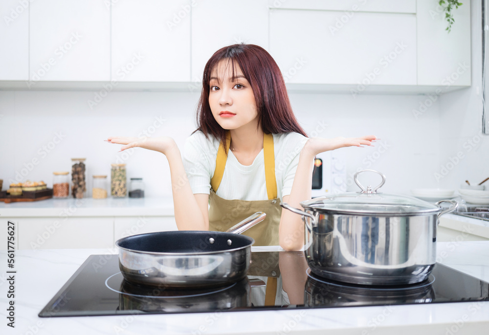Image of young Asian woman in the kitchen Image of young Asian woman in the kitchen