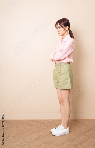 Full length photo of young Asian woman standing on background © Timeimage
