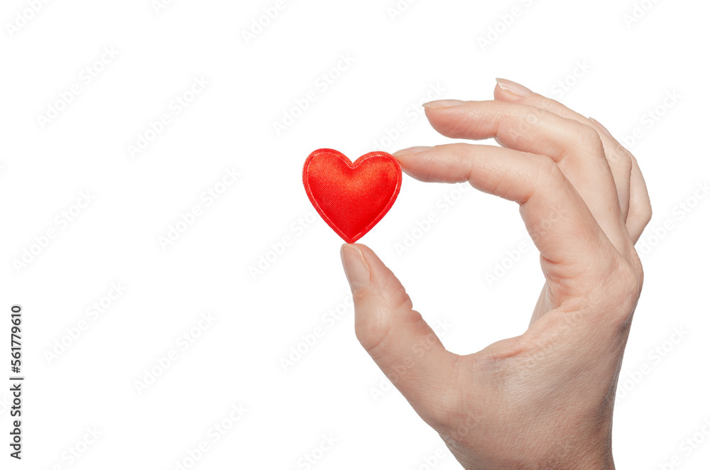 Small red heart in female fingers. Holiday symbol. Small red heart in female fingers. Holiday symbol.