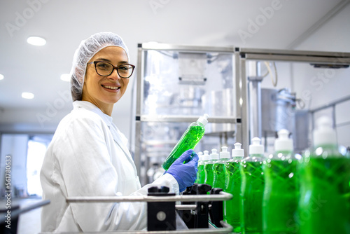 Portrait of female technologist controlling production of cleaning supplies or sanitation chemicals for cleaning industry.