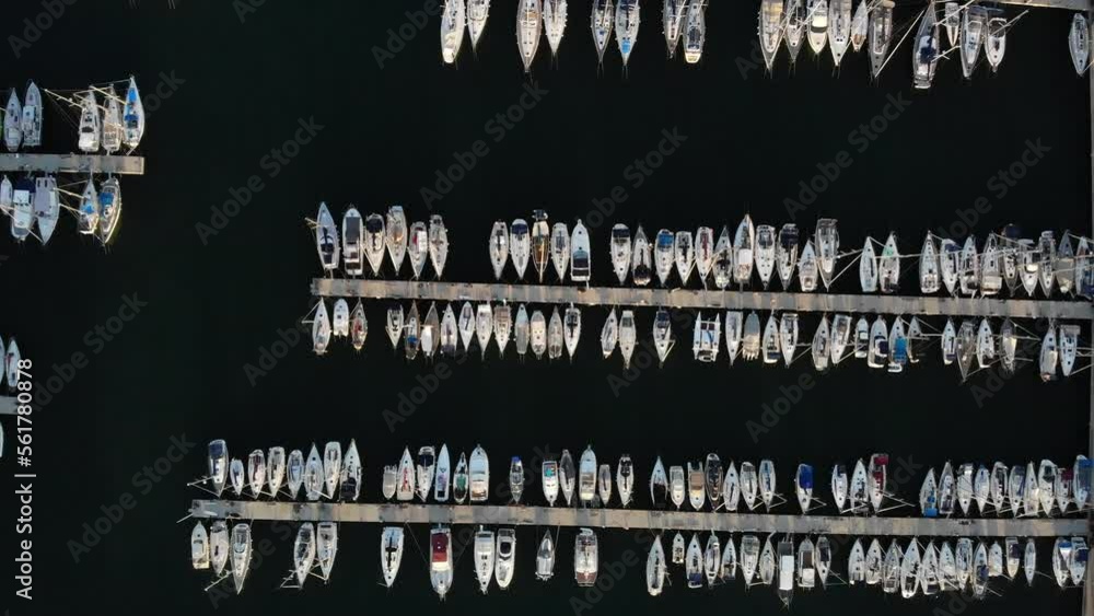 Drone view of moored sailboats in marina at sunset in a Port de Badalona Drone view of moored sailboats in marina at sunset in a Port de Badalona