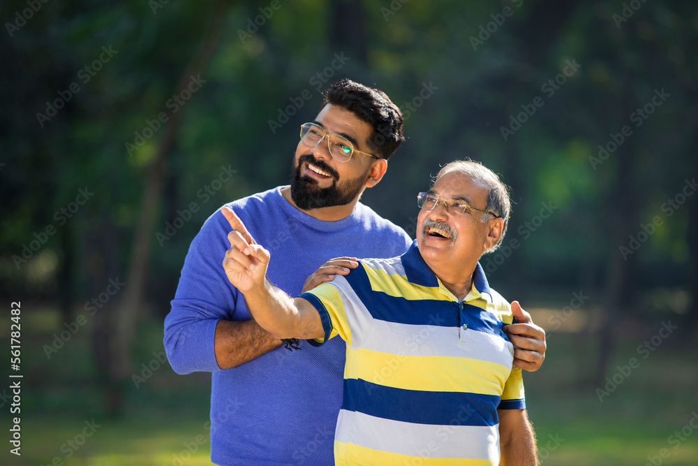 Young indian man with his father at park. Young indian man with his father at park.