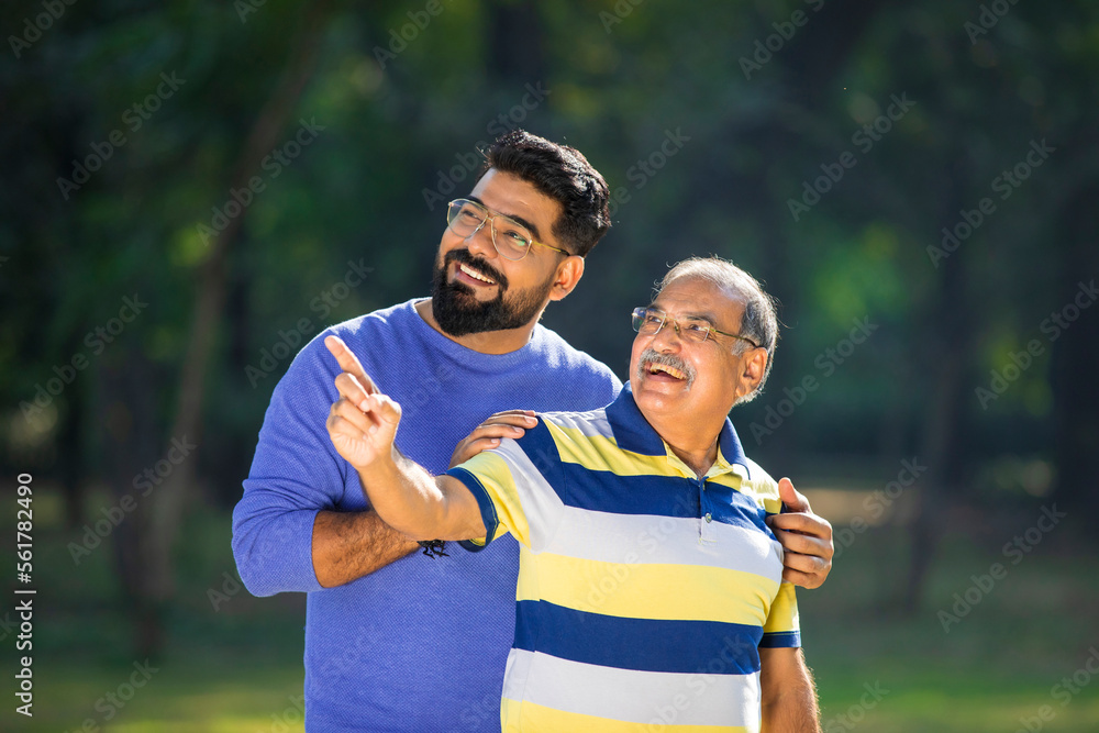 Young indian man with his father at park. Young indian man with his father at park.