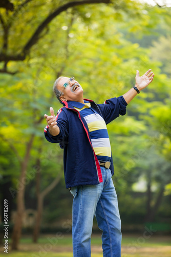 Indian old man giving expression at park