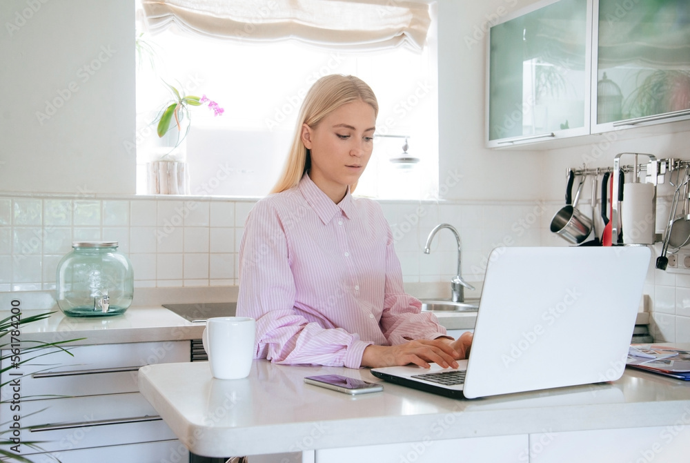 Young attractive blonde girl is working or studying from a home office. Horizontal mockup. Young attractive blonde girl is working or studying from a home office. Horizontal mockup.