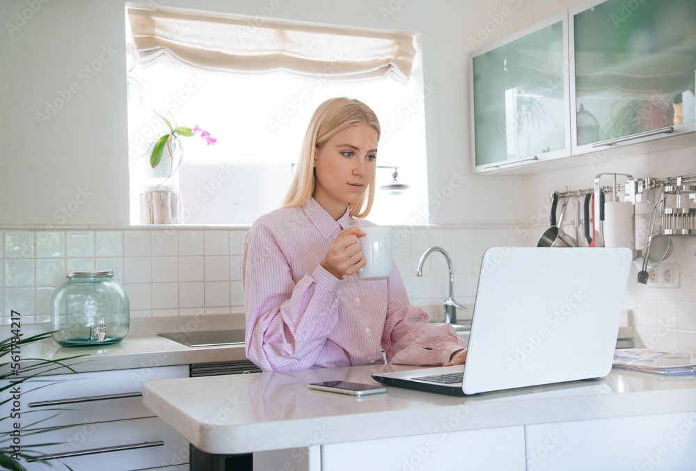Young attractive blonde girl is working or studying from a home office. Horizontal mockup. Young attractive blonde girl is working or studying from a home office. Horizontal mockup.