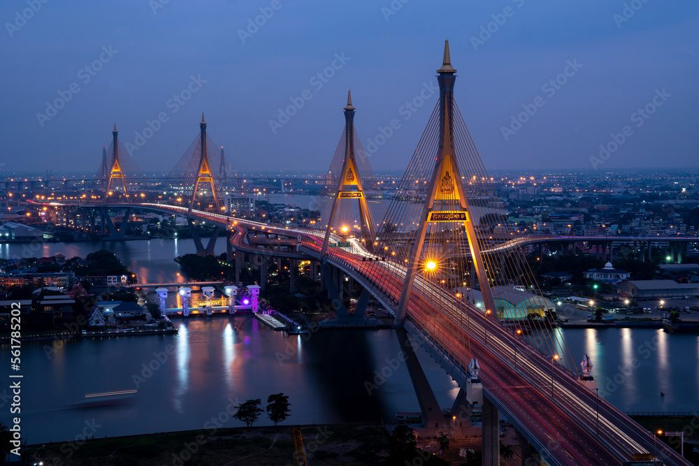 Obraz premium View of Bhumibol Bridge across the Chao Phraya River at night is a landmark of Bangkok and is a cargo road from the port to the city, Thailand.