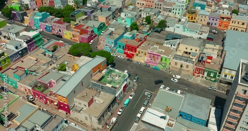 A drone flies over a modern and beautiful South African city at sunset. Aerial view of Cape Town which is located on the ocean. One of the richest cities in Africa