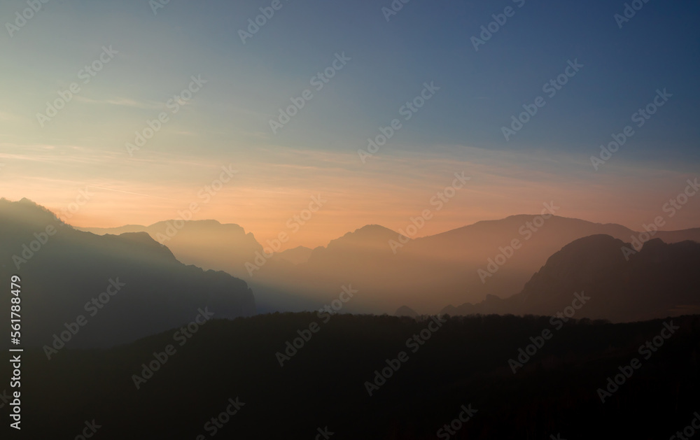 Landscape with the ridges of the Apuseni mountains - Romania in a foggy evening