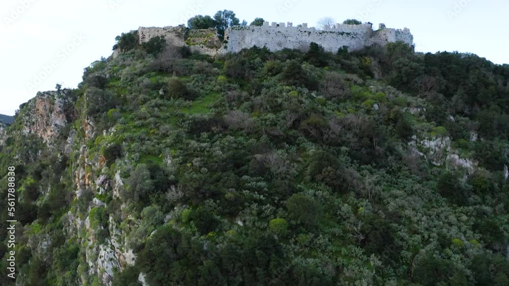 Drone view of Old Navarino Castle and Nestor’s Cave at the bottom of hill Drone view of Old Navarino Castle and Nestor’s Cave at the bottom of hill