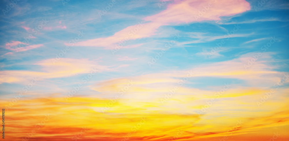 Sunset with sun and clouds on blue and orange dramatic sky with sun rays Sunset with sun and clouds on blue and orange dramatic sky with sun rays