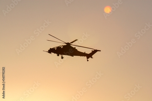 military helicopter in the evening sky