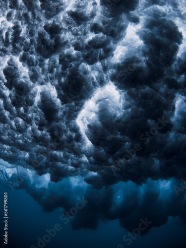 Ocean wave and foam underwater with clear water. Underwater clouds made by powerful wave