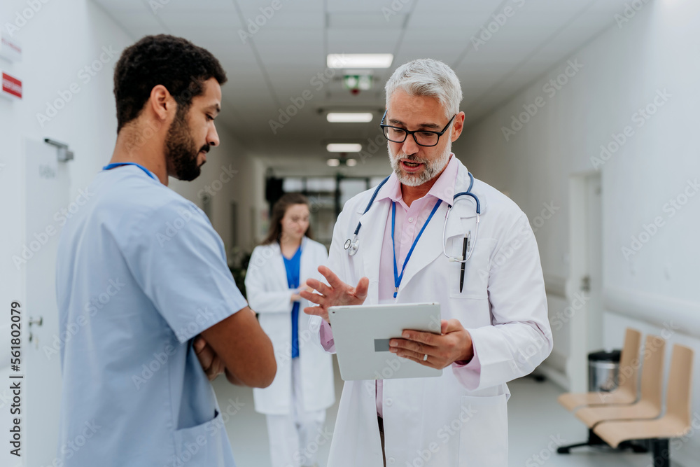 Doctors discussing something at the hospital corridor. Doctors discussing something at the hospital corridor.