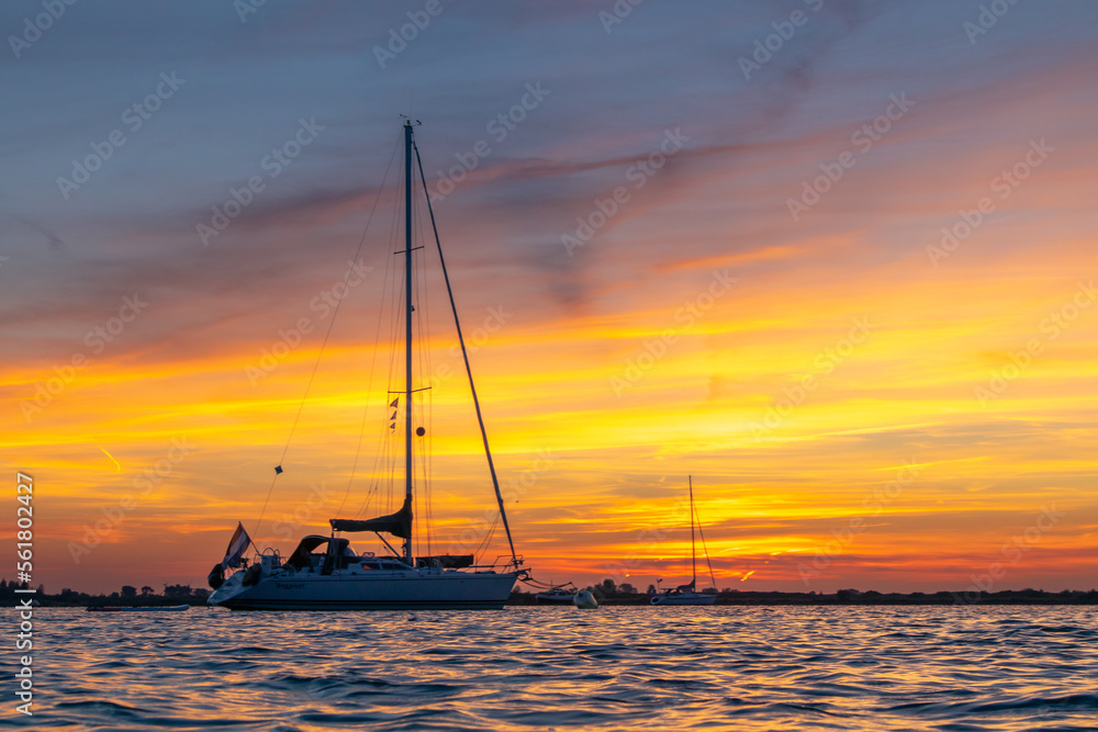 Sailing boat anchored with dramatic sunset