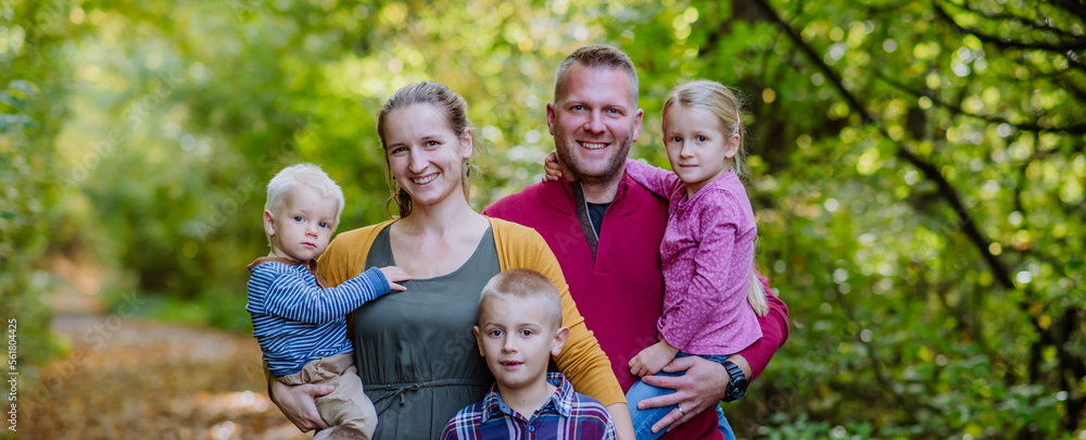 Portrait of happy family with kids in a forest. Portrait of happy family with kids in a forest.
