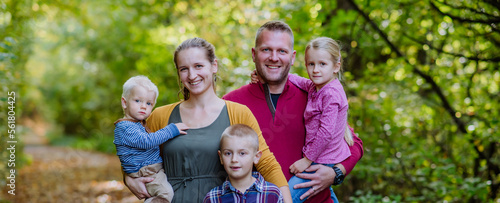Portrait of happy family with kids in a forest.