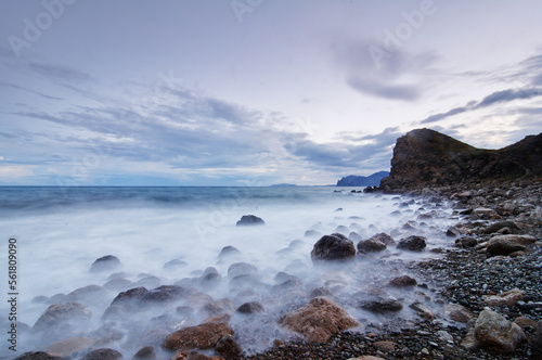 Beautiful landscape with rock sea beach and cloudy sky.