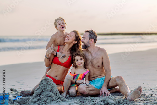 Photography Happy family with little kids enjoying time at sea in exotic country