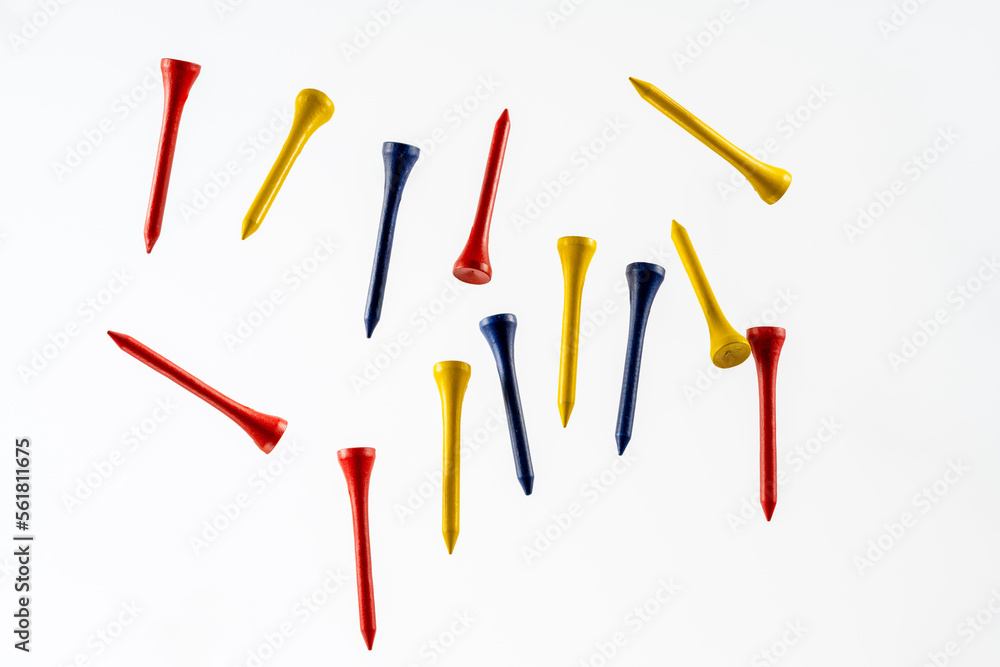 color wooden bamboo golf tees fallnig through the air isolated on a wooden background color wooden bamboo golf tees fallnig through the air isolated on a wooden background