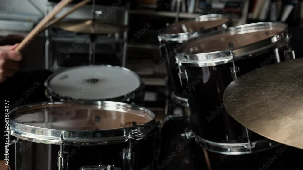 Man hands playing on drums and bronze cymbal plates with drumsticks live concert. Musician during percussion musical instrument perfomance indoors Man hands playing on drums and bronze cymbal plates with drumsticks live concert. Musician during percussion musical instrument perfomance indoors