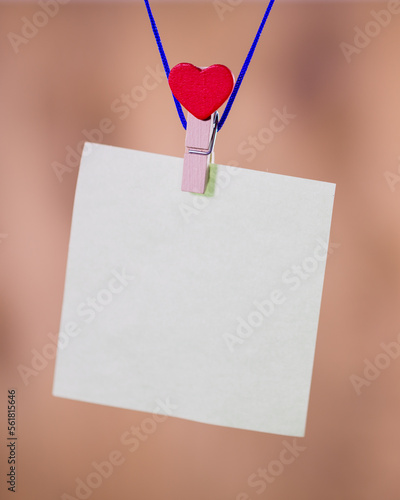 Heart clothes peg holding note